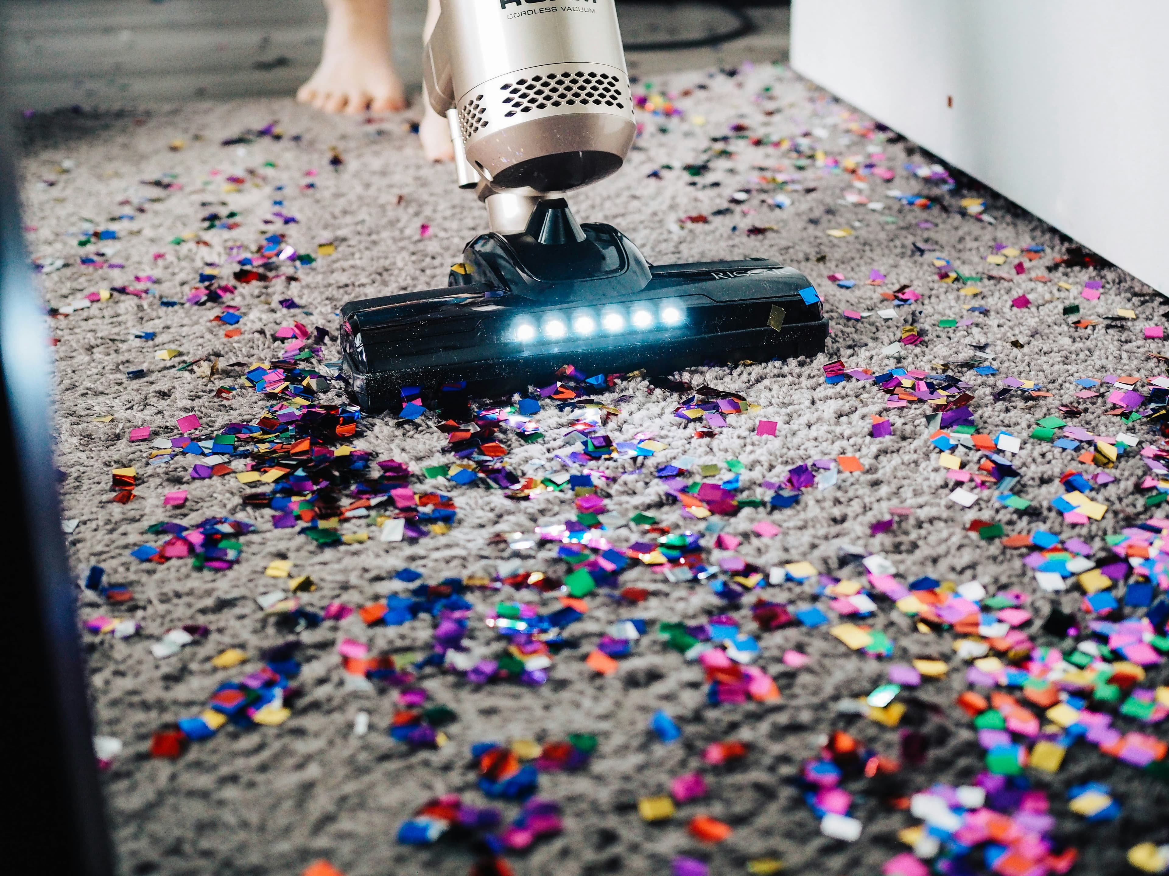 A professional cleaner tidying a bright, modern UK home